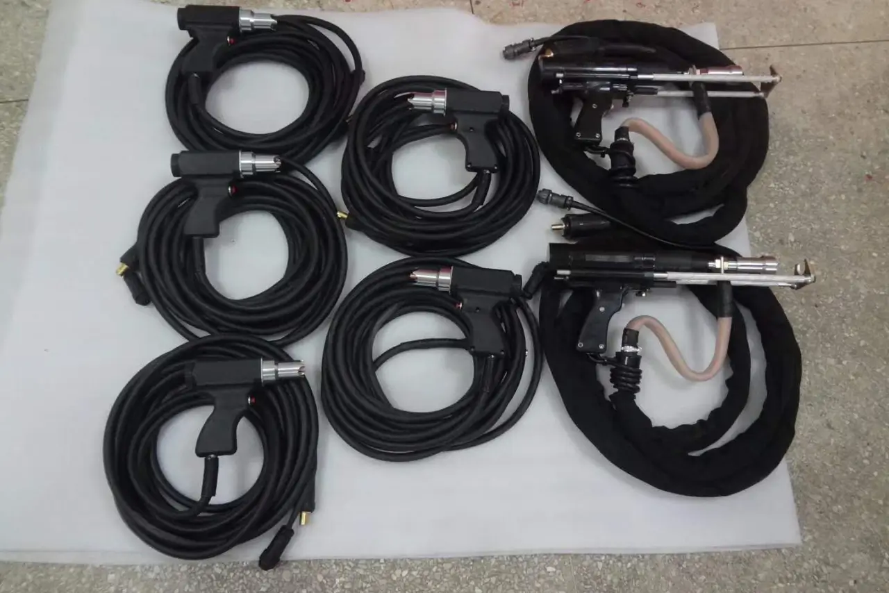 A display showing five standard capacitor discharge guns alongside two heavy-duty drawn arc guns for technical comparison.
