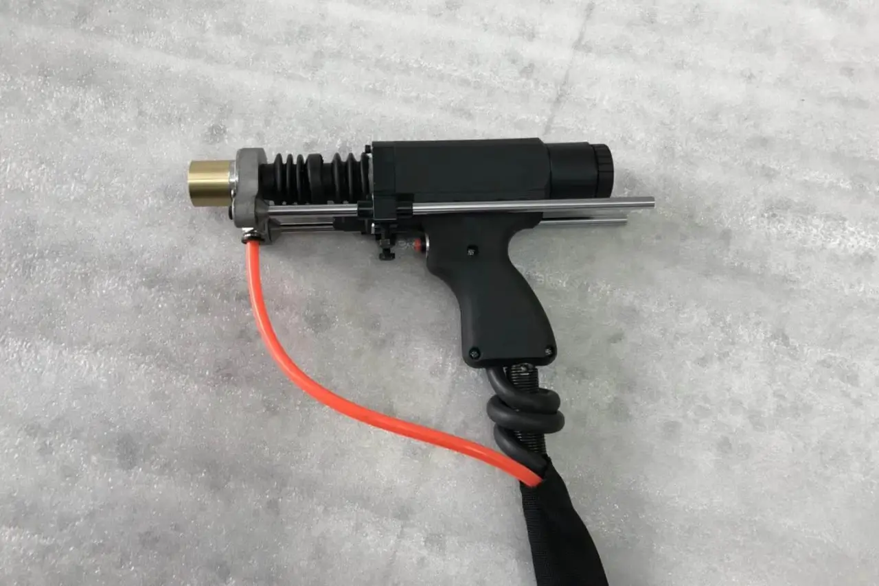A heavy-duty drawn arc stud welding gun with a high-heat protective orange tube and adjustable dual-rail stabilizing system.