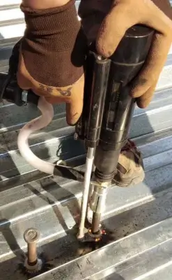 Customer using a stud welding gun to weld studs onto a profiled steel deck sheet.