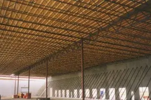 Industrial roof decking construction reinforced with weld studs for strong metal sheet attachment.