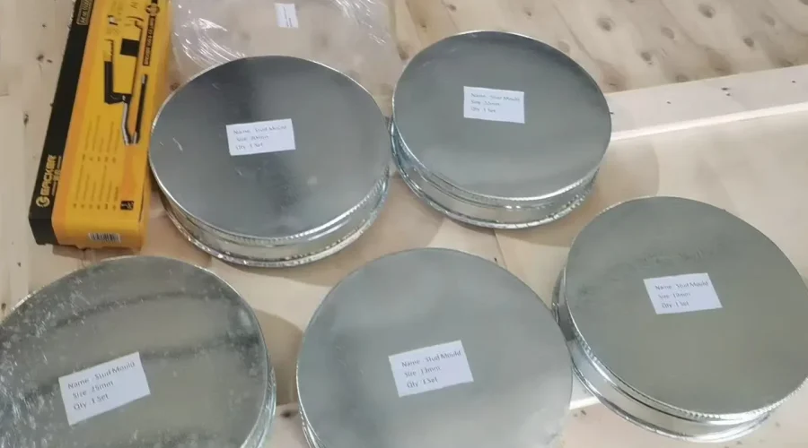 Specialized stud molds and accessory kits for the flux ball riveting machine organized for shipment.