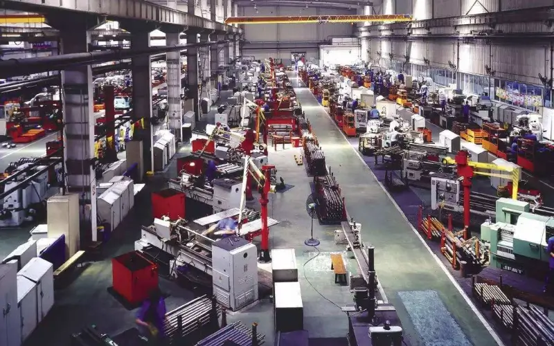A busy industrial factory floor with multiple production lines and machinery, illustrating ZOC Machinery's equipment used in general manufacturing.