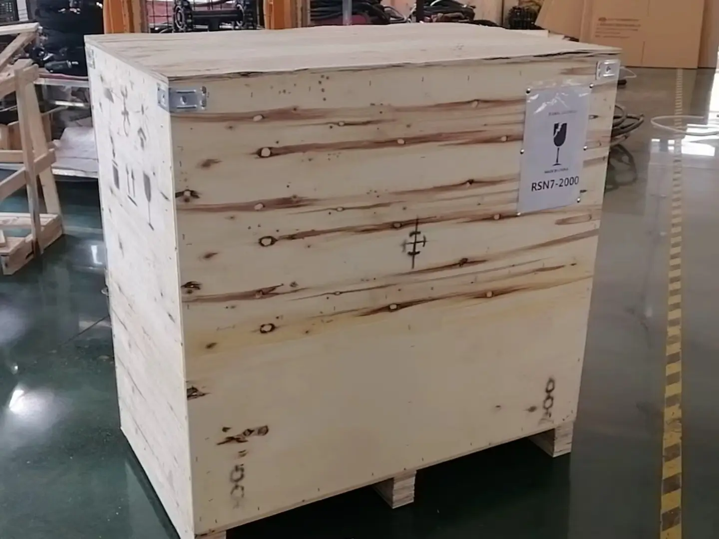 Heavy-duty wooden crating of stud welding machines for international shipping, highlighting compliance with logistics safety standards.
